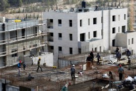 Labourers work at a construction site in the Israeli settlement of Ramot in an area of the occupied West Bank that Israel annexed to Jerusalem