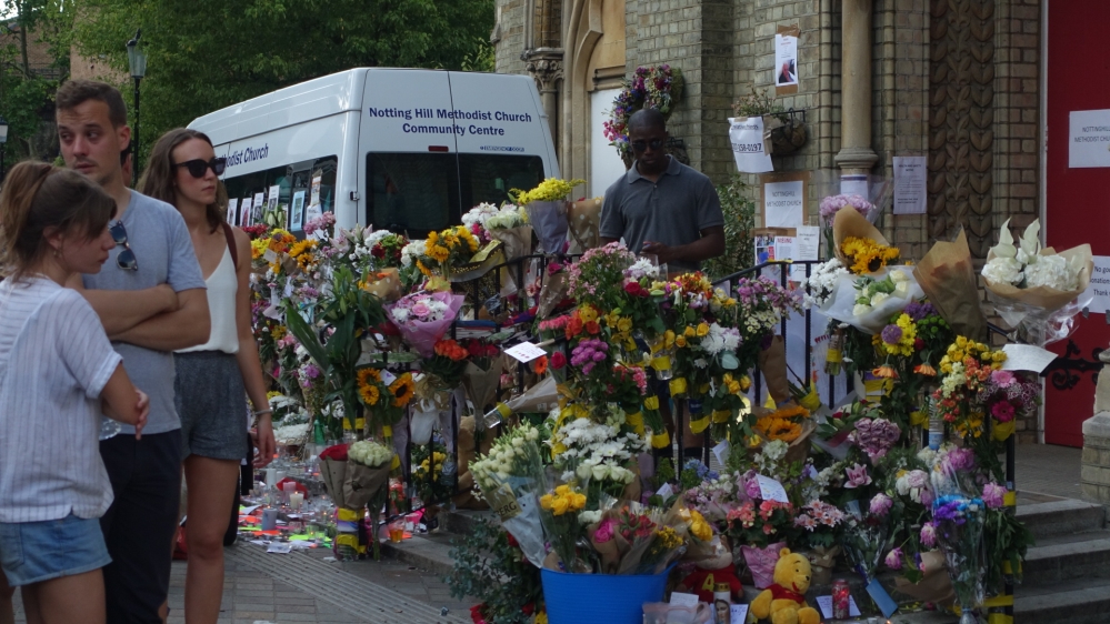 Tributes for victims at a church close to Grenfell Tower [Shafik Mandhai/Al Jazeera] 