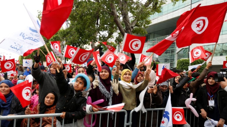 People wave national flags during celebrations marking the sixth anniversary of Tunisia''s 2011 revolution in Habib Bourguiba Avenue in Tunis