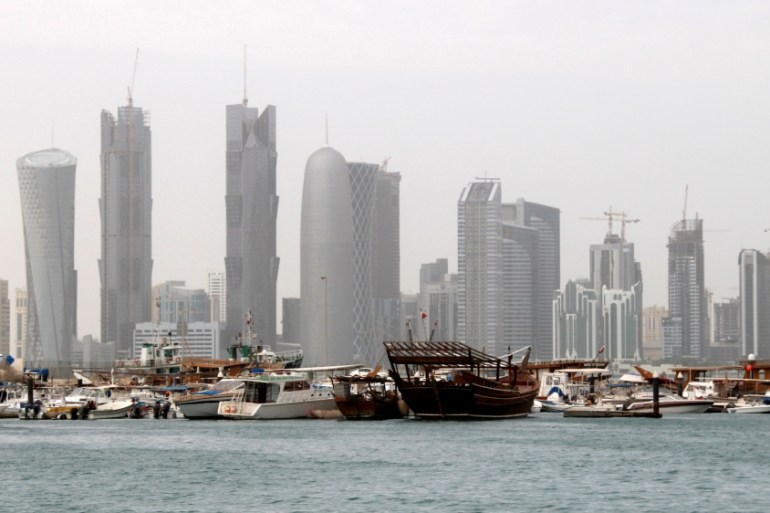 FILE PHOTO: Traditional fishing Dhows are seen in port near modern glass and steel buildings on the Doha skyline