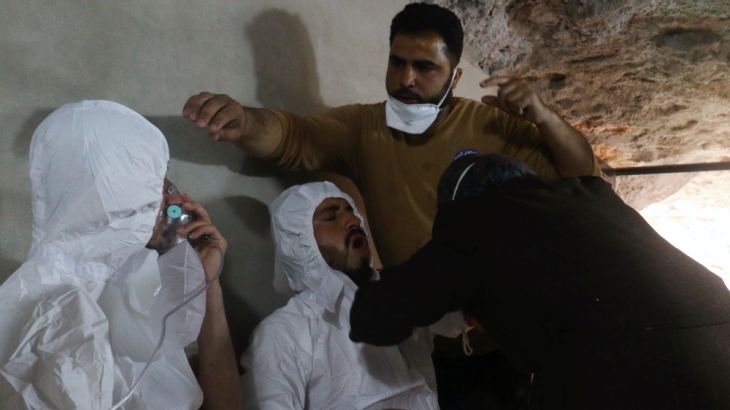 A man breathes through an oxygen mask as another one receives treatments, after what rescue workers described as a suspected gas attack in the town of Khan Sheikhoun in rebel-held Idlib