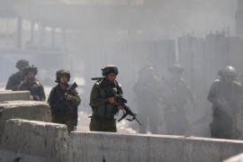 Israeli soldiers take position during clashes with Palestinians protesters following a protest in solidarity with Palestinian prisoners held by Israel, near Qalandiy