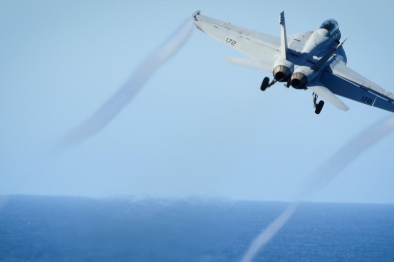 FILE PHOTO: An F/A-18E Super Hornet takes off from the flight deck of a U.S. Navy aircraft carrier