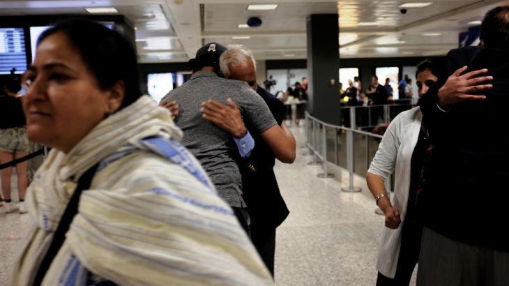 International passengers embrace family members as they arrive at Washington Dulles International Airport
