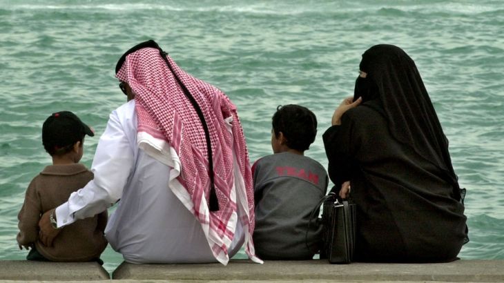 A Qatari family watches a powerboat race in Doha