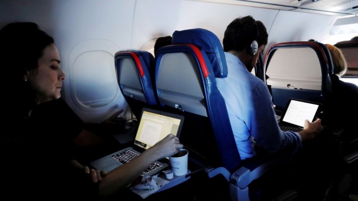 FILE PHOTO -- Passengers use their laptops on a flight out of JFK International Airport in New York