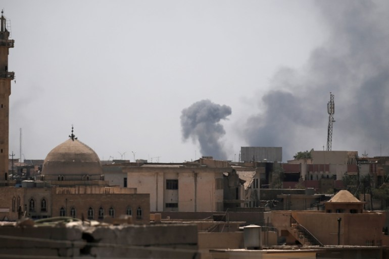 Smoke billows from the positions of the Islamic State militants after an artillery attack by the Iraqi forces in western Mosul