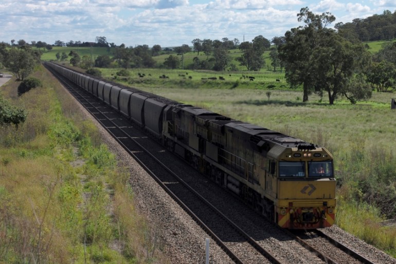 An Aurizon coal train travels through the countryside in Muswellbrook, north of Sydney, Australia