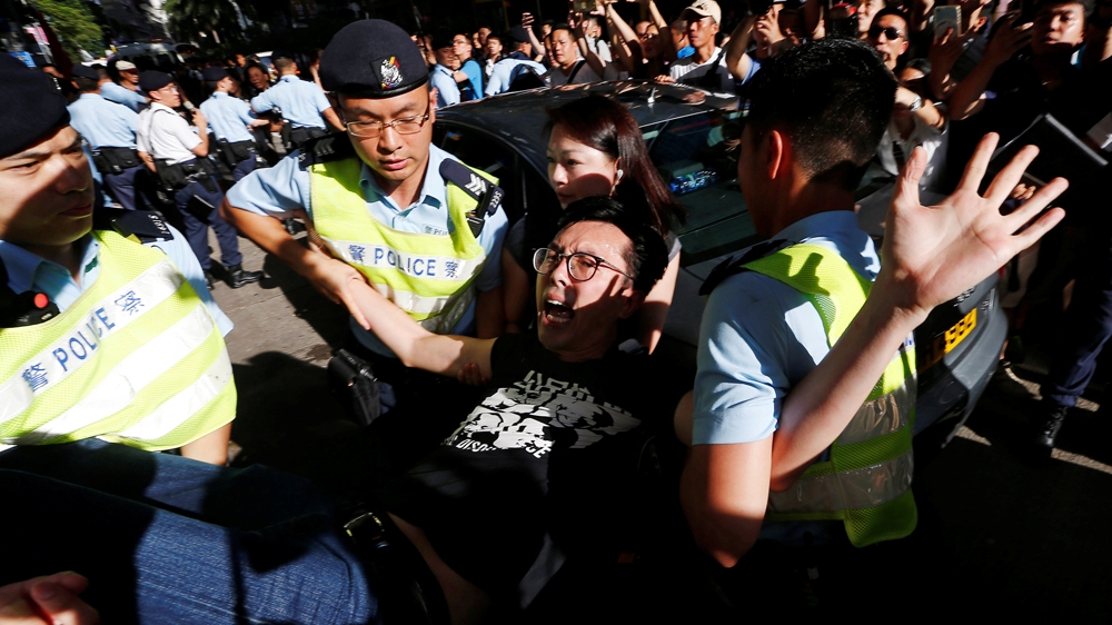 Pro-democracy activist Avery Ng is detained by police as he takes part in a protest demanding the release of Chinese Nobel rights activist Liu Xiaobo [Reuters]