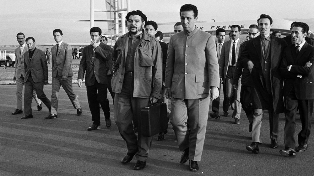 Ernesto 'Che' Guevara walks with Algeria's president Ahmed Ben Bella at Algiers airport in 1964. A year later, Guevara returned to Algeria for the Afro-Asian Conference [The Associated Press]