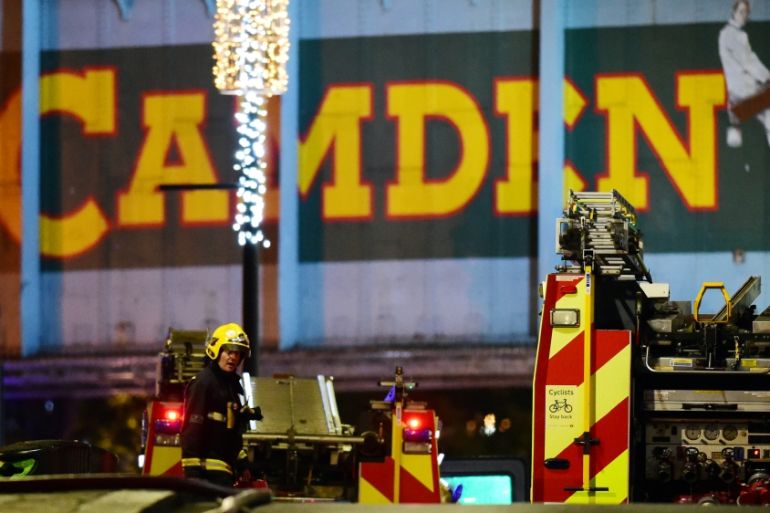 A firefighter walks at the scene of a fire at Camden Market in north London