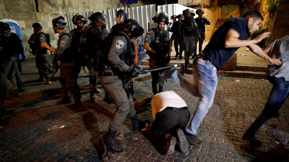 Israeli border police clash with Palestinian men during scuffles that erupted after Palestinians held evening prayers outside the Lion's Gate of Jerusalem's Old City July 18, 2017. REUTERS/Ammar Awad [Reuters]