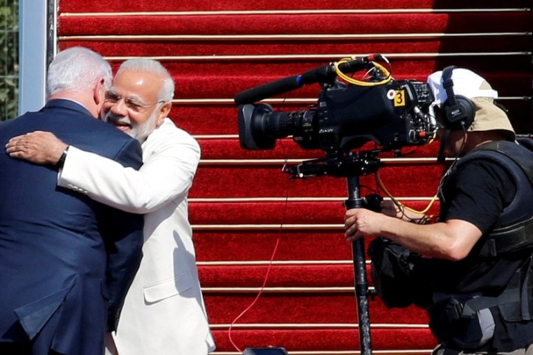 Israeli Prime Minister Benjamin Netanyahu hugs Indian Prime Minister Narendra Modi during an official welcoming ceremony upon his arrival to Israel at Ben Gurion Airport