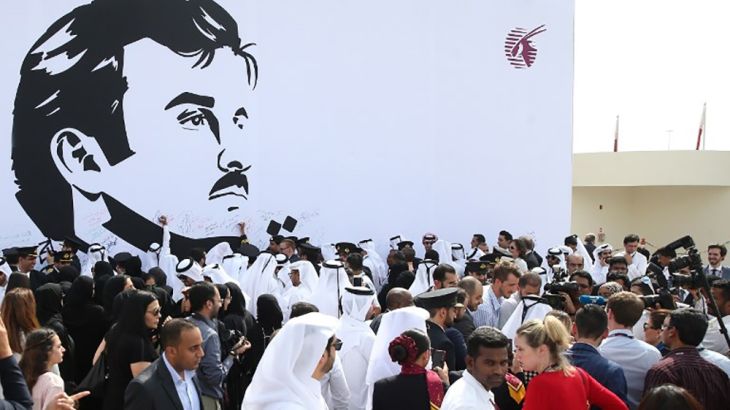 Qatar Airways Group employees stand in front of a wall bearing a portrait of Qatar''s Emir Sheikh Tamim bin Hamad Al Thani during a gathering to showcase support to the country and its leader, in Doha