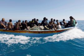 Migrants ride in a boat after they were rescued by Libyan coastguard off the coast of Gharaboli, east of Tripoli