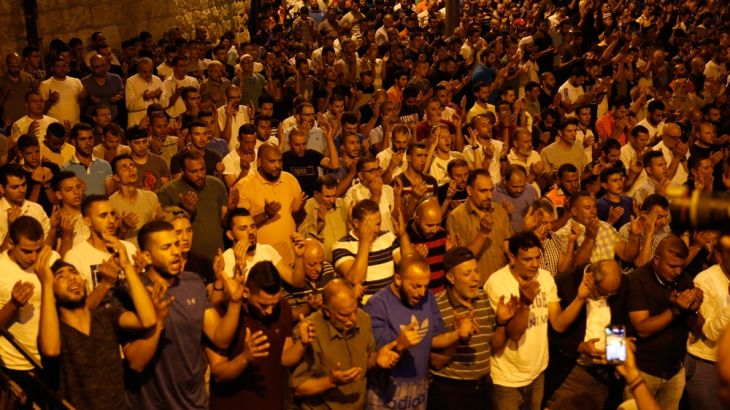 Palestinian Muslim worshippers pray outside Lion''s Gate which leads to the Al-Aqsa compound in Jerusalem''s Old City