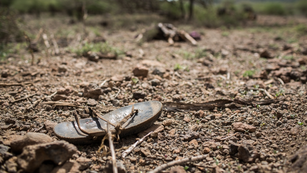 A sandal lies near the remains of 80-year-old Ekurio Mugeluk [Will Swanson/Al Jazeera]