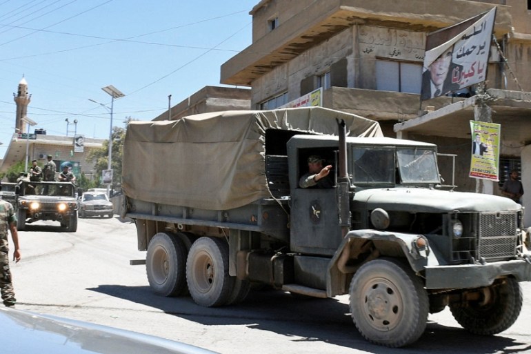 A convoy of Lebanese army soldiers drives at the entrance of the border town of Arsal, in eastern Bekaa Valley