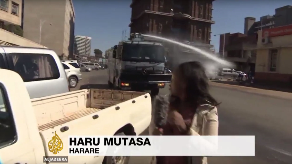 A water cannon truck fired in the direction of Al Jazeera reporter Haru Mutasa [Al Jazeera]