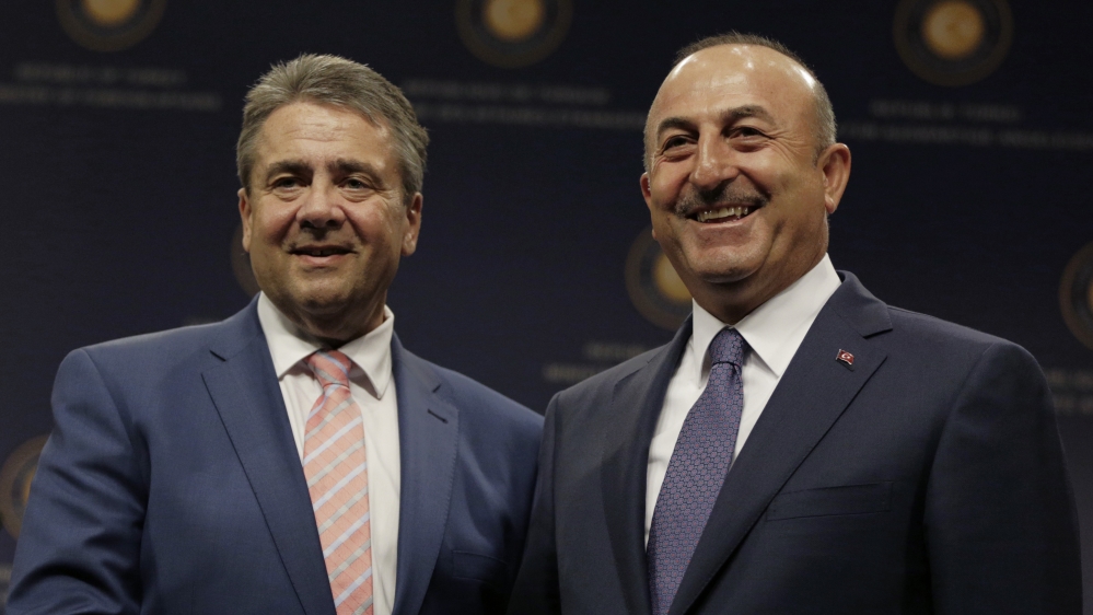 Gabriel, left, and Cavusoglu have engaged in a war of words over the Turkish arrests [File: AP]