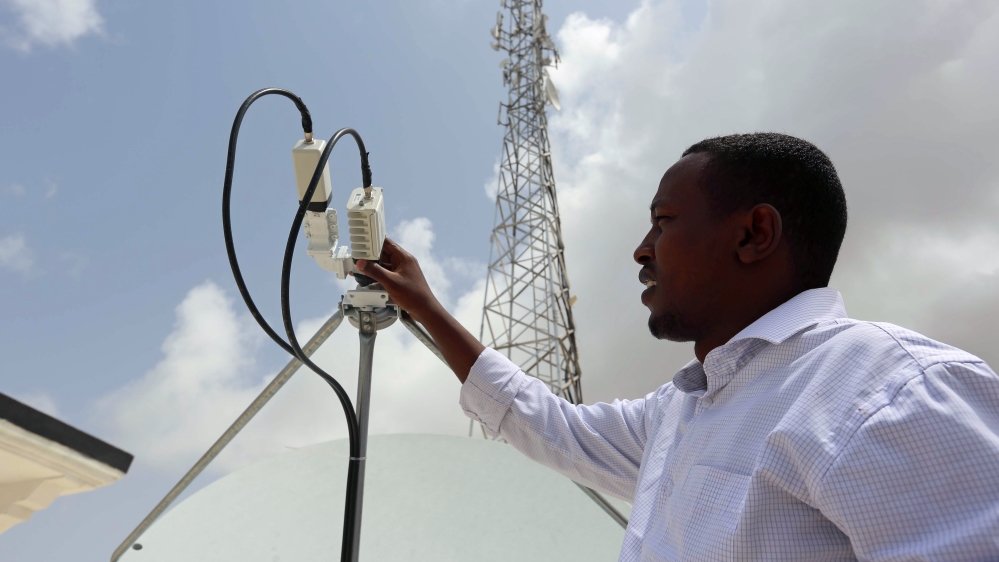A Somali Optical Networks (SOON) technician checks a satellite dish at their headquarters in Mogadishu Somalia. [Feisal Omar/Reuters]