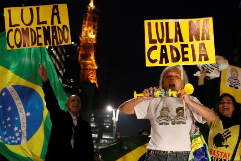 People celebrate after former Brazilian President Luiz Inacio Lula da Silva, was convicted on corruption charges and sentenced to nearly 10 years in prison in Sao Paulo
