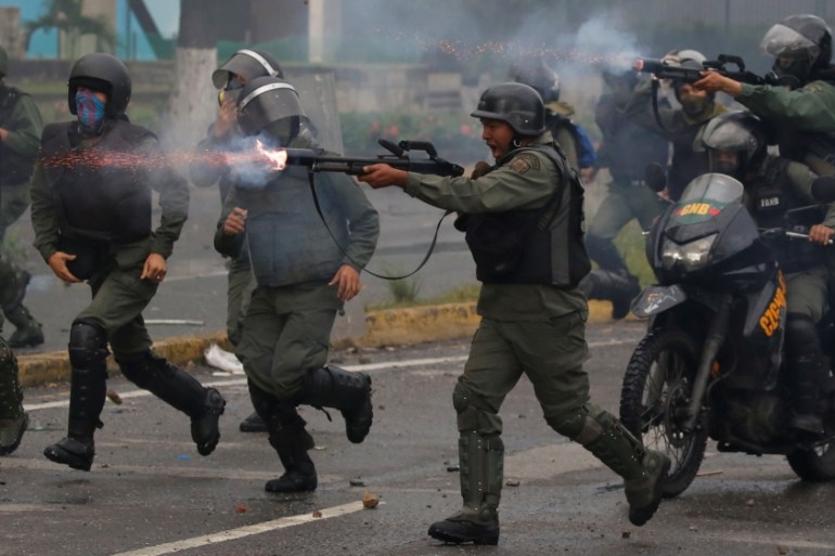 Riot security forces take up positions while clashing with demonstrators rallying against Venezuela''s President Nicolas Maduro''s government in Caracas