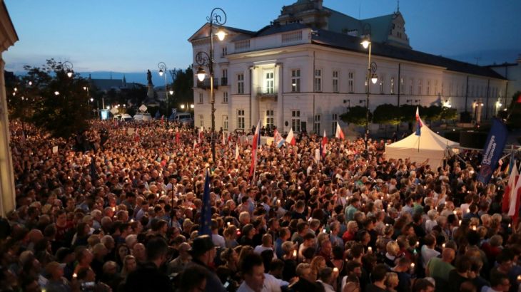 People attend candlelit rally against supreme court legislation in front of the Presidential Palace in Warsaw