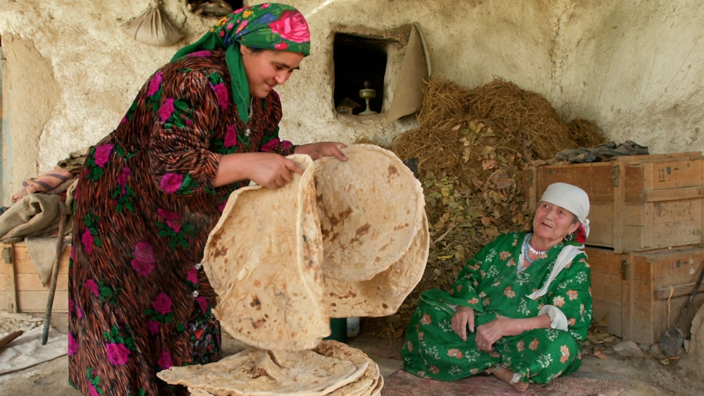 Women cook fresh traditional bread in the Karasu region, 30 km east of the Tajik capital Dushanbe[ Alexei Vladykin/AP]