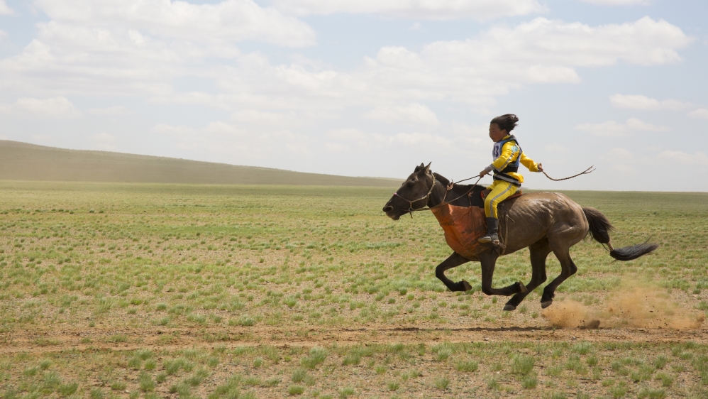 Bujinlkham during the 24km horse race held as part of the Naadam festival [Hannah Griffin/Al Jazeera]