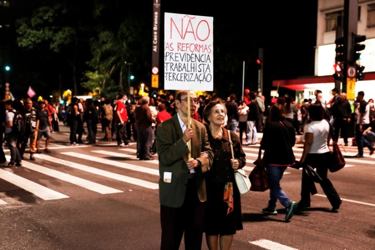 Pensioners hold a banner that reads "Not to social security, labour and outsourcing reforms" during a protest against President Michel Temer''s proposed economic reforms in Sao Paulo