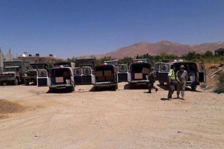 Hezbollah ambulances are seen carrying the coffins of bodies of Nusra Front fighters in Labwe