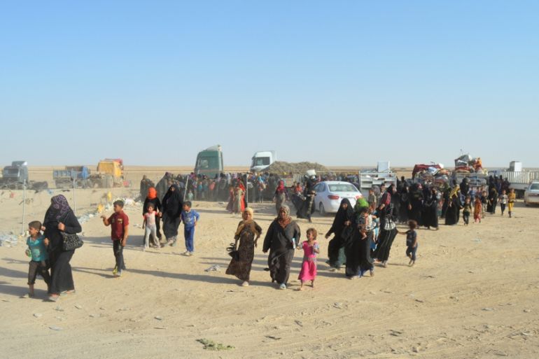 People displaced by violence from Islamic State militants, arrive at a military base in Ramadi