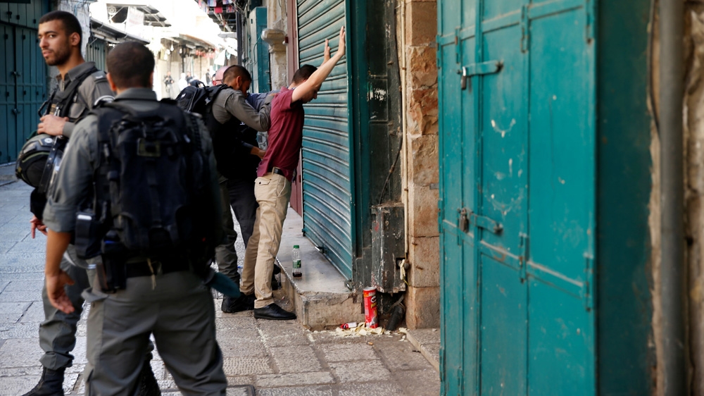Israeli policemen performed body searches in Jerusalem's Old City after the shooting [Ammar Awad/Reuters]