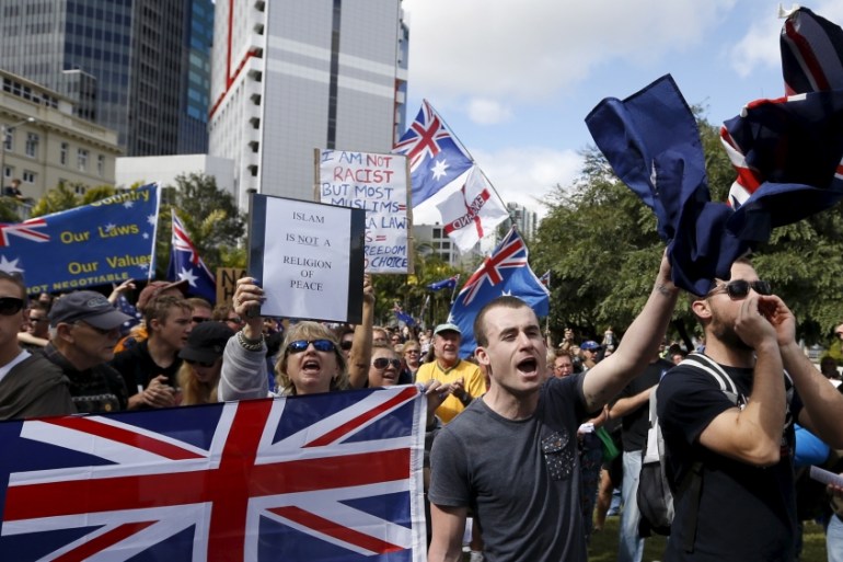Protestors against Islam in Australia hold up various banners during a "Reclaim Australia" protest in Brisbane
