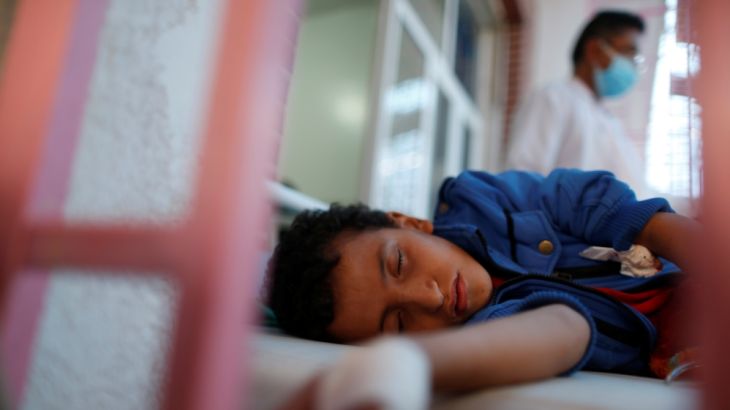 Boy lies on a bed at a cholera treatment center in Sanaa, Yemen