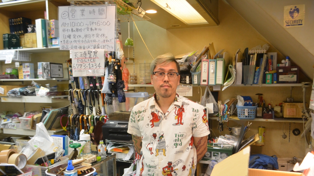 Kenji Takahashi buys unclaimed items from the police to sell in his Osaka shop [JJ O'Donoghue/Al Jazeera] 