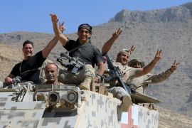 Lebanese army soldiers are seen flashing victory signs in the town of Ras Baalbek