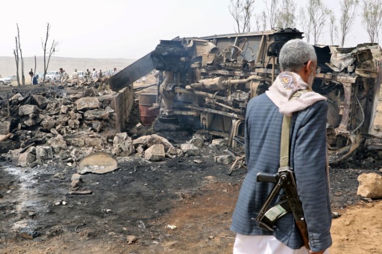 A man walks at the site of a Saudi-led air strike on an outskirt of the northwestern city of Saada