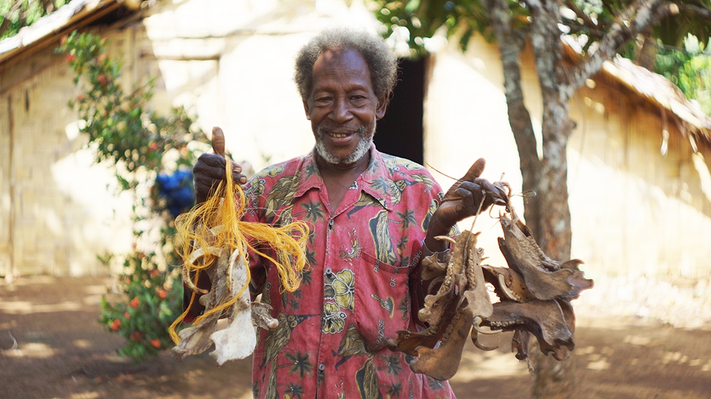 A chief in northern Pentecost proudly displays his collection of pigs' tusks, which are used as a means of commerce across the island [Edward Cavanough/Al Jazeera]