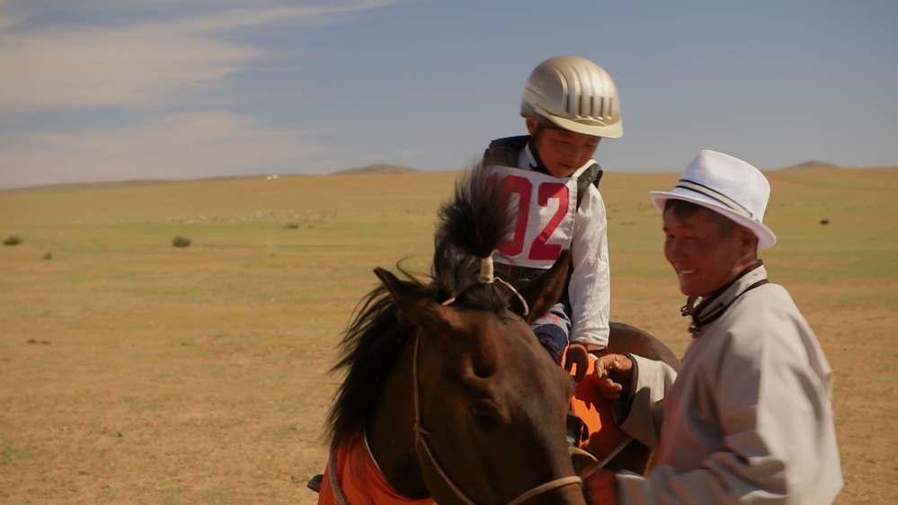 Mongolian law states that children must be at least seven years old to compete in horse races. But Al Jazeera found riders as young as five [101 East/Al Jazeera] 