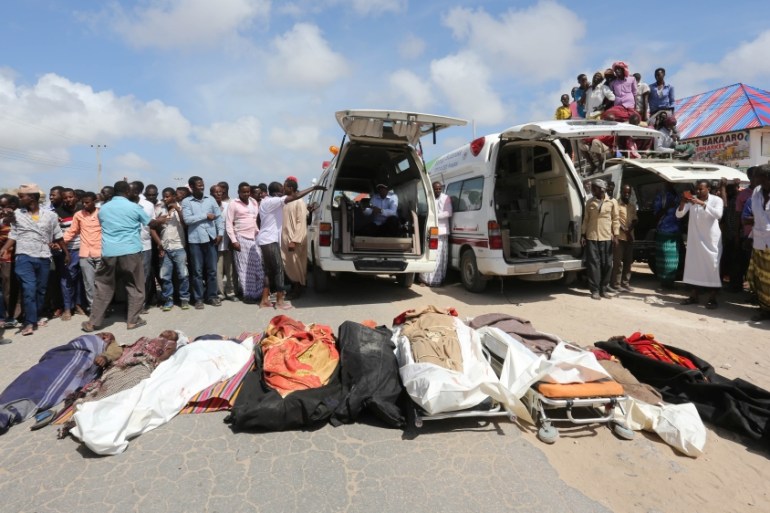 Relatives stand near the bodies of farmers killed in an attack by Somali forces and supported by U.S. troops in lower Shebelle Region