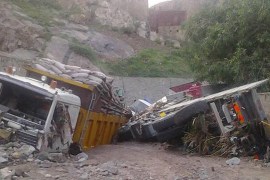 Heavy rains sweep away cars and trucks on a side road near Taiz