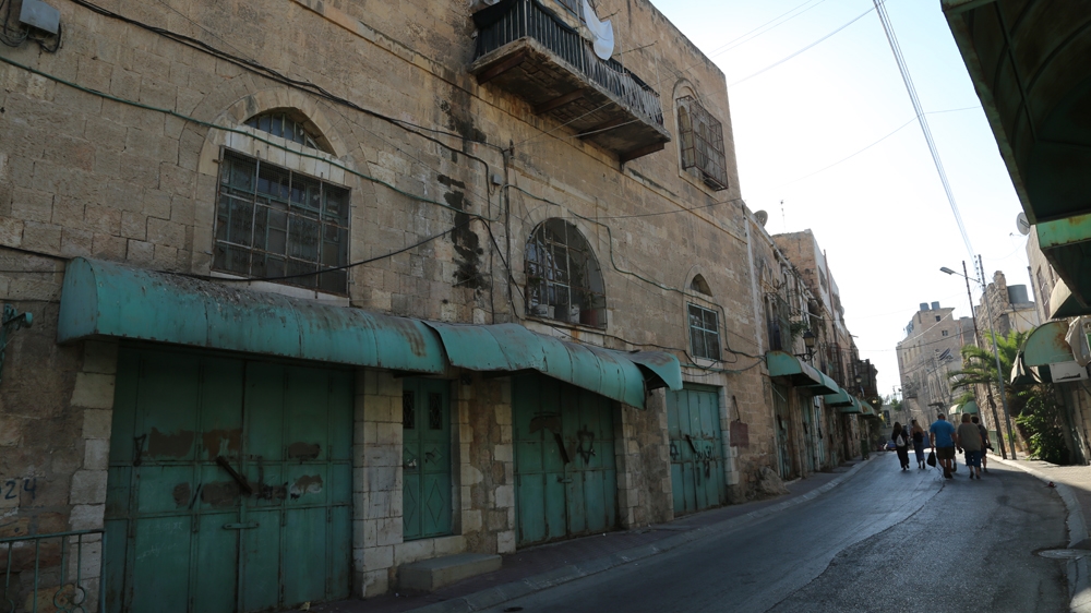 Hebron's Old City resembles a ghost town, with abandoned homes and closed shops lining the streets [Mersiha Gadzo/Al Jazeera]