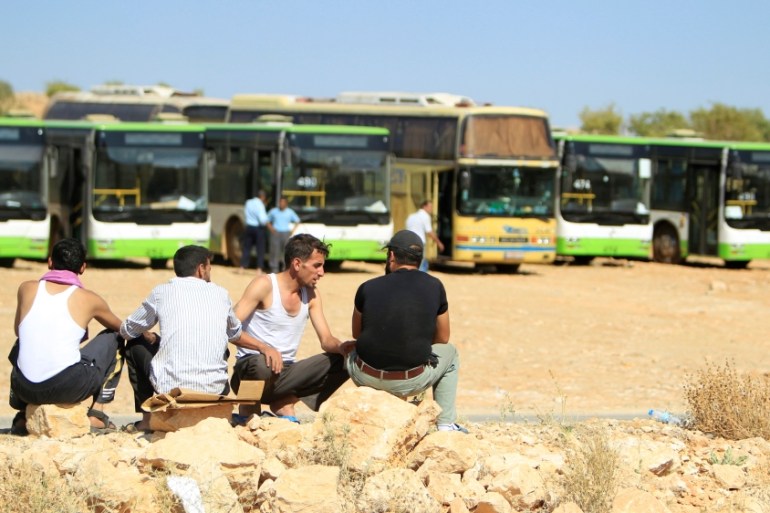 Bus drivers sit together in Jroud Arsal, near Syria-Lebanon border