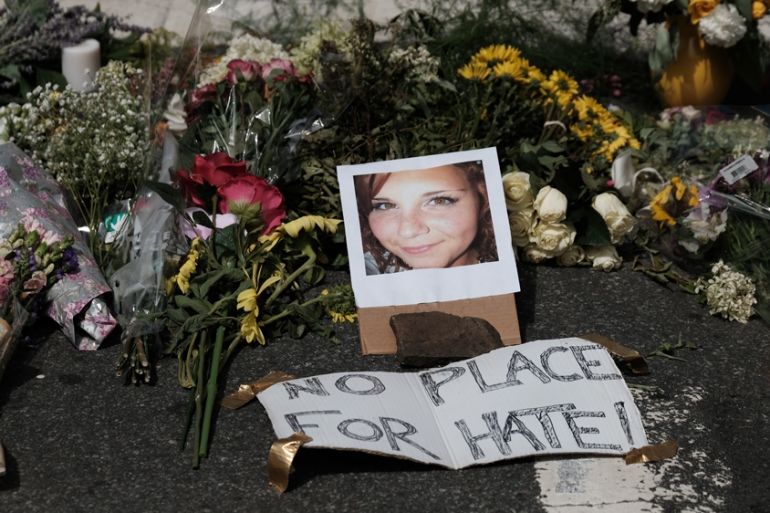 Flowers and a photo of car ramming victim Heather Heyer lie at a makeshift memorial in Charlottesville, Virginia,