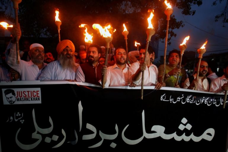 Protesters hold lamps to condemn the killing of Abdul Wali Khan university student Mashal Khan, after he was accused of blasphemy, during a protest in Peshawar