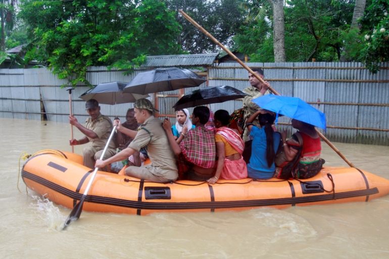 Members of Tripura State Rifles evacuate people from a flooded area after heavy rains in Baldakhal village on the outskirt of Agartala