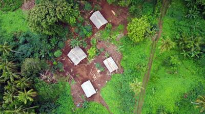 A small village on the mud track to Lavatmengamu in northeast Pentecost is seen by drone [Edward Cavanough/Al Jazeera]