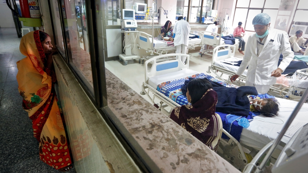 A woman looks into the intensive care unit (ICU) at the Baba Raghav Das hospital [Cathal McNaughton/Reuters]